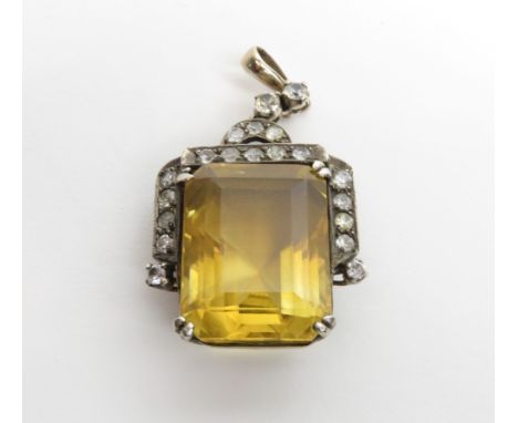 A citrine pendant, the large step cut stone measuring approximately 23mm by 17 mm by 12 mm deep, within a mount set with colo