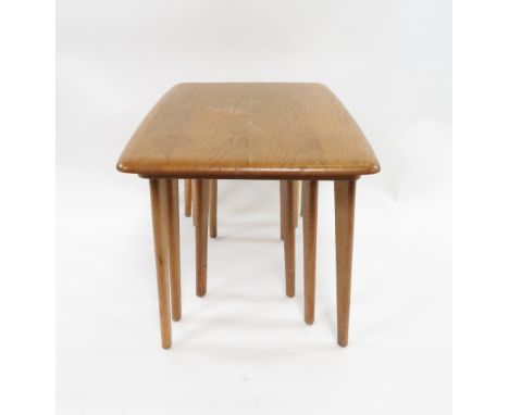 A nest of three Ercol beech and elm tables