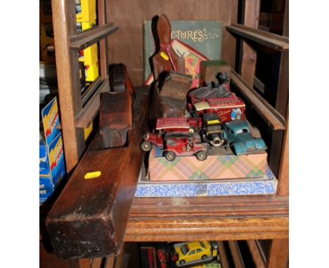 An eclectic assortment of old hand tools and model cars, games, etc 