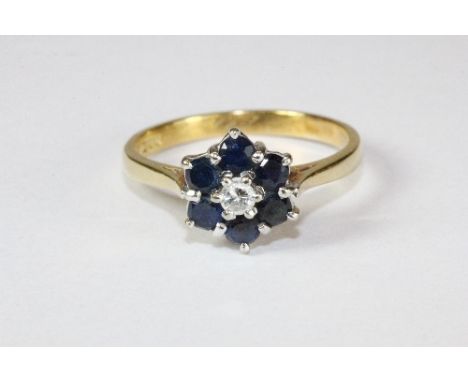 An 18ct gold sapphire and diamond cluster ring (M)