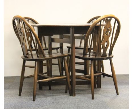 An Ercol oak drop leaf cottage dining table and chairs