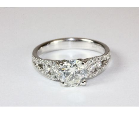 A lovely 18ct white gold diamond solitaire (1.18ct) ring with diamond set shoulders (additional 0.48ct) (N)