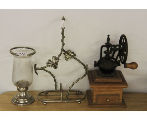 A vintage coffee grinder, wine rack and storm lantern