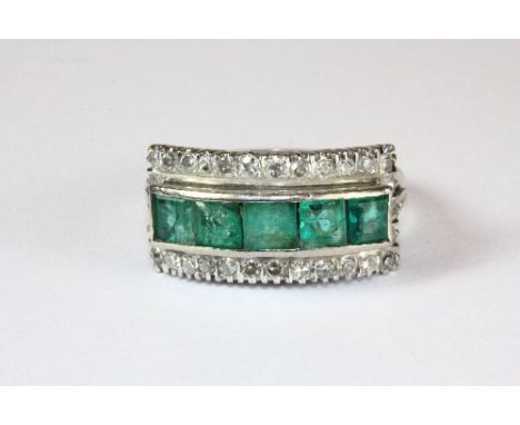 An Art Deco white metal (tested high carat) emerald and diamond ring (N.5)