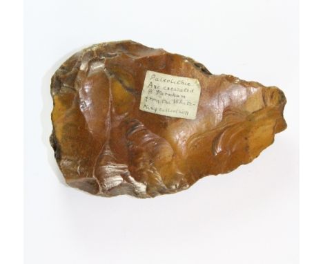 A Palaeolithic axe head excavated at Farnham originally from the Sir Lucas-White King (1856 - 1925) collection, L 12cm