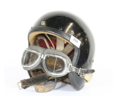 A vintage motorcycle helmet and goggles