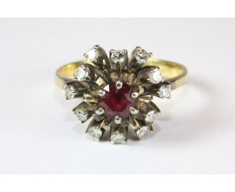 An 18ct gold ruby and diamond cluster ring (Q)