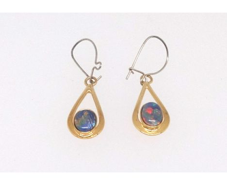 A pair of opal pendant drop earrings set in yellow metal, boxed.