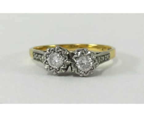 An 18ct two stone diamond ring, size N.