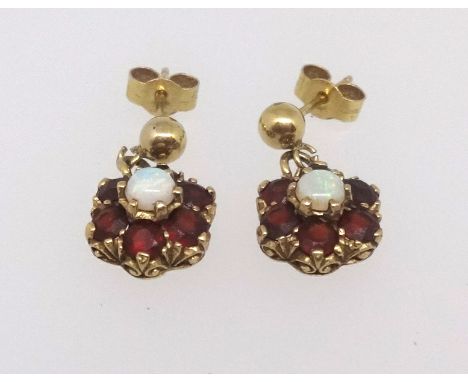 A pair of garnet and opal cluster earrings set in yellow metal.