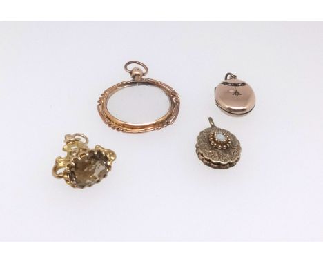 A magnifying glass in yellow metal mount, an antique gilt locket set with opal, a gilt and ornate fob set with citrine and an