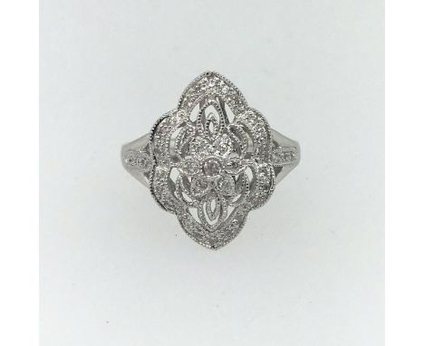 A platinum and diamond set decorative ring, size M.