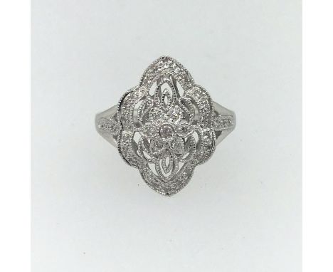 A platinum and diamond set decorative ring, size M.