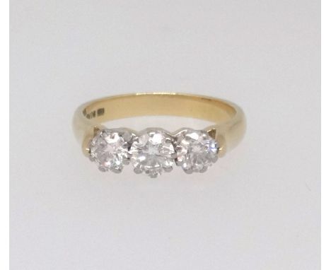 A good 18ct three stone diamond ring together with a copy of the insurance valuation indicating three brilliant cut stones we