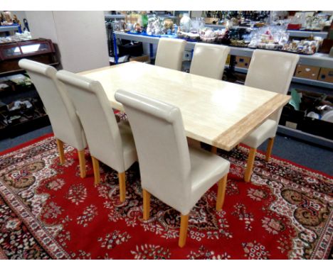 A contemporary faux marble dining table and six high back chairs upholstered in cream leather, together with a coffee table a