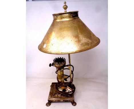 A brass retro style table lamp in the form of an oil lamp on paw feet.