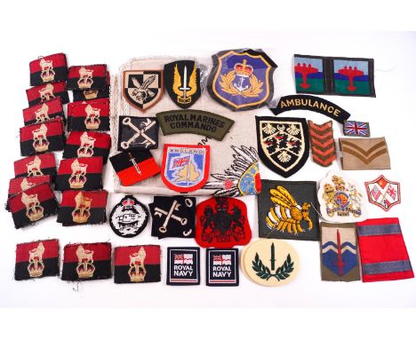 A group of assorted militaria comprising a large assortment of arm badges, etc including examples from the US army