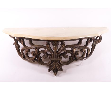 A composite wall console bracket with a shaped cream stone top on a pierced scrolling acanthus bracket, 58cm wide x 22cm deep