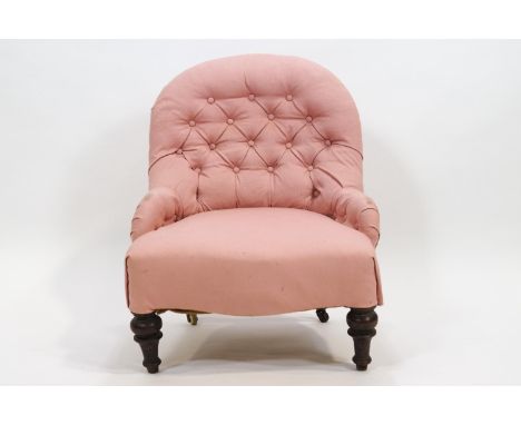 A 19th century button backed nursing chair raised on turned legs, 75cm high x 56cm wide x 60cm deep
