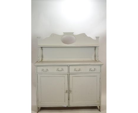 A painted chiffonier of usual form with shaped and pierced back over a book shelf raised on two pillars to the plain rectangu