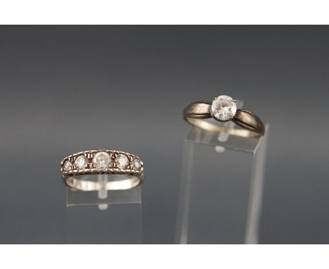 A collection of two white metal dress rings each set with colourless cubic zirconia. Both marked 925 sterling silver. Size N 