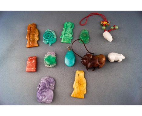 A group of twelve hard stone/jade carvings and pendants. Gross weight: 128.6 grams