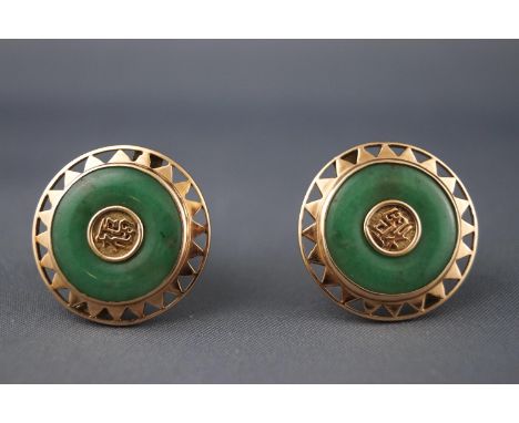 A yellow metal pair of circular cufflinks. Set with a commercial green jade and finished to the centre with a Chinese symbol.