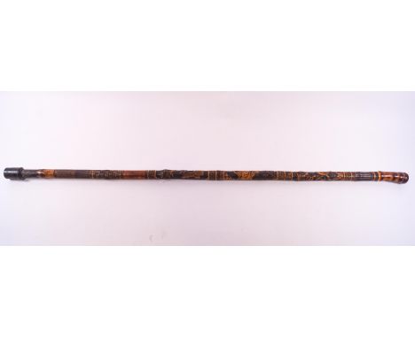 A Japanese bamboo walking stick carved with panels of birdlife, a Geisha and butterflies.92 cm long.