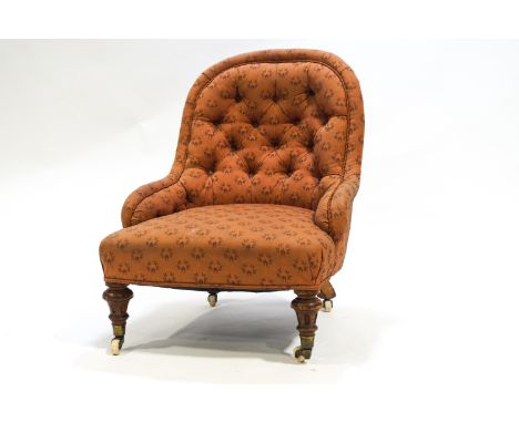 A Victorian nursing chair with button back and turned and fluted legs