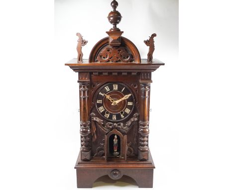 A 19th century hardwood and pine Black Forest combination strike and bellows clock, the plain rectangular top set with a dome