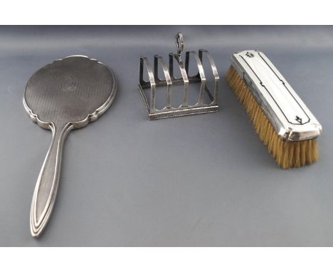 A silver four slice toast rack, of Art deco form with central strap handle and shaped uprights set over a bead edged finely p