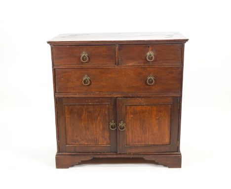 An oak cupboard set with two short and one long drawer over two plain panelled doors raised on bracket feet, 96cm high x 96cm