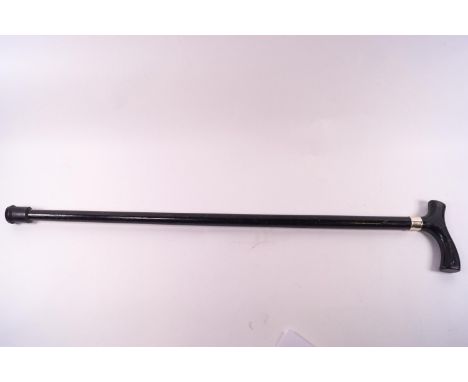 An ebonised walking stick with white metal collar, 79cm high