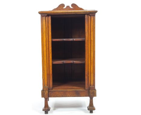 A mahogany music cabinet with a shaped cresting rail over a plain rectangular top over a three shaped shelf rack with fold ou