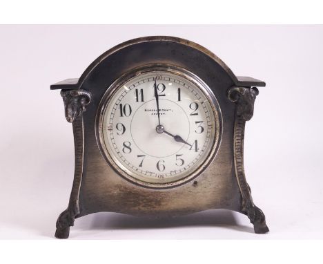 A Kendal &amp; Dent mantle clock in arched metal case enclosing an enamel dial, 16cm high