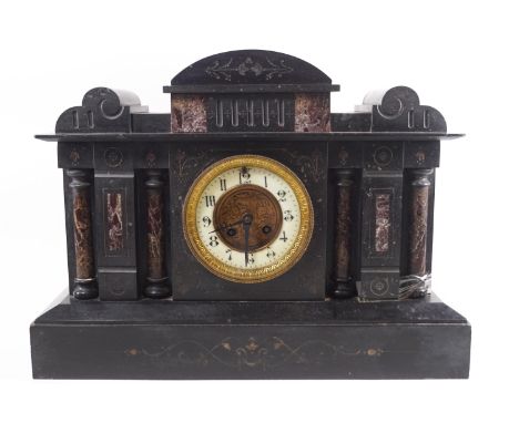 A slate and serpentine Temple clock with four engaged doric columns centred with an ivorine dial with an eight day strike mov