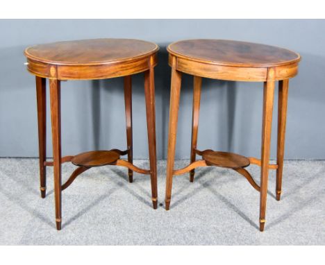 A Pair of Edwardian Mahogany and Inlaid Oval Two Tier Lamp Tables, each with cross banded edge to top, frieze inlaid with str
