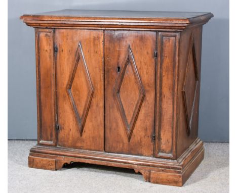 A 17th Century Italian Walnut Cabinet, with moulded edge to top, fitted one shelf enclosed by a pair of doors with applied lo