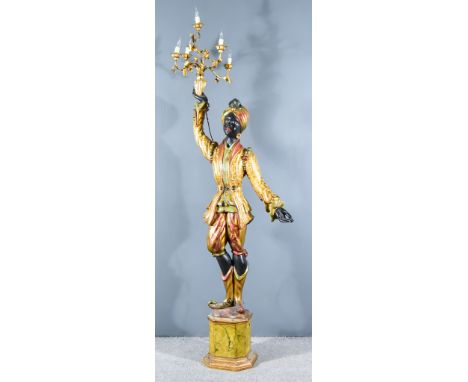 An Italian Giltwood Blackamoor Pattern Standard Lamp, the standing figure of a Moorish boy wearing a gilt jacket decorated in