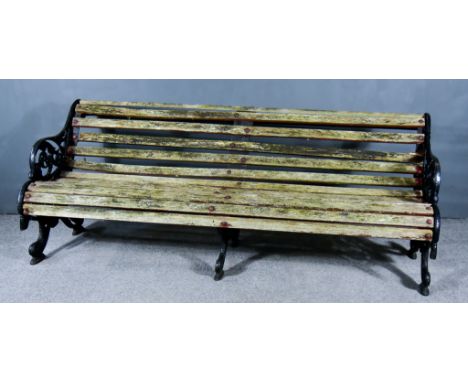 A Late Victorian Black Painted Cast Iron "Falkirk" Pattern Park Bench, the ends with leaf scroll ornament, slatted seat and b