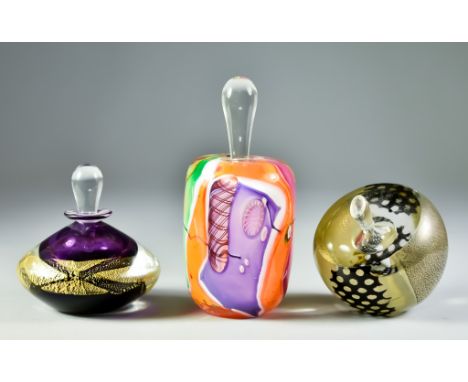 Three Studio Glass Scent Bottles and Stoppers, comprising - a James Wilbat glass studio mosaic bottle and stopper, signed, 6i