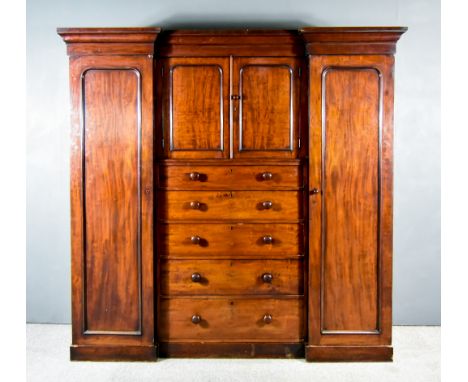 A Victorian Mahogany Breakfront Wardrobe, by Heal &amp; Son of London,&nbsp;with moulded cornice, the recessed centre fitted 