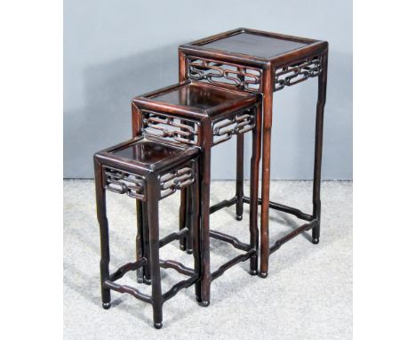 A Nest of Three Chinese Rosewood Occasional Tables,&nbsp;with panelled tops, the aprons with fretted scroll ornament, on bamb