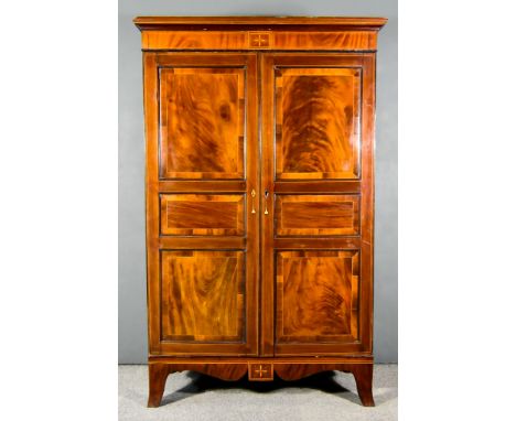 A George III Figured Mahogany Wardrobe, the whole&nbsp;inlaid with stringings and cross bandings, with moulded cornice, enclo