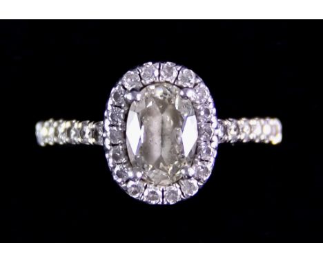A Platinum Diamond Halo Ring, set with a centre oval diamond, approximately 1ct, surrounded by small brilliant cut white diam
