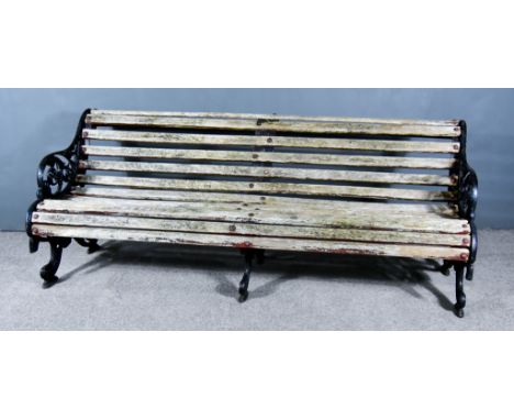 A Late Victorian Black Painted Cast Iron "Falkirk" Pattern Park Bench, the ends with leaf scroll ornament, slatted seat and b