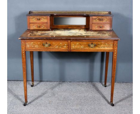 An Edwardian Rosewood and Inlaid Writing Table,&nbsp;the superstructure with pierced brass gallery, inset with central mirror
