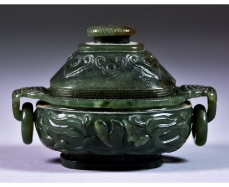 A Chinese Dark Green Jade Two-handled Koro and Cover, carved with stylised leaf scrolls, and with ring pattern handles, 4ins 