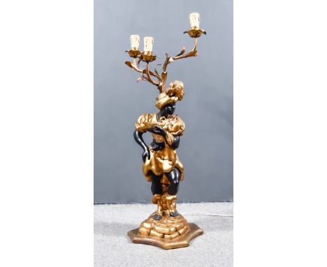 A 20th Century Continental Painted and Gilt Composition Blackamoor Candelabra, with three leaf capped branches and electric c