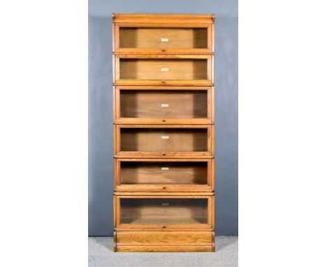 An Early 20th Century Oak Six Tier Globe Wernicke Sectional Bookcase, each section with ivorine plaque 'The Globe - Wernicke 